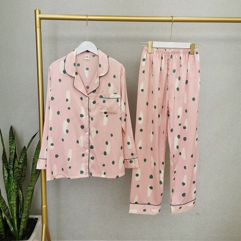 Zweiteiliger rosafarbener Herbstpyjama mit langen Ärmeln für Frauen auf einem Gürtel in einem Haus