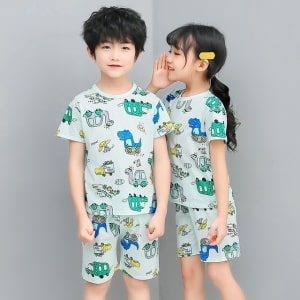 Zweiteiliger grüner Pyjama mit Cartoon-Druck für Kinder mit zwei Kindern, die den Pyjama tragen, und einem grauen Hintergrund